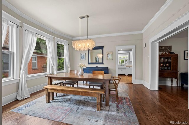 5675 S Crocker St, Littleton, CO 80120 - dining area featuring wood finished floors, a chandelier, crown molding, and baseboards