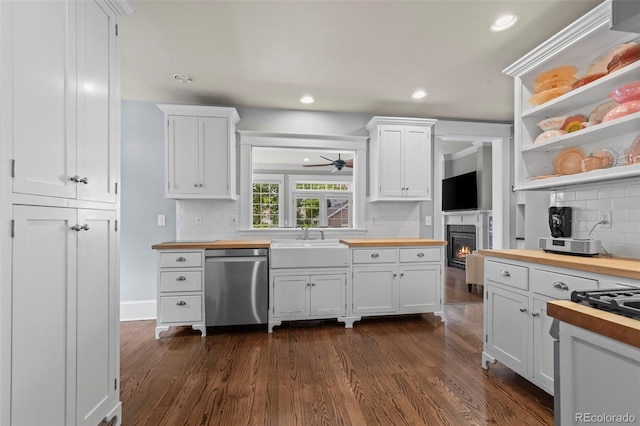 5675 S Crocker St, Littleton, CO 80120 - kitchen with butcher block countertops, stainless steel dishwasher, a sink, tasteful backsplash, and white cabinets
