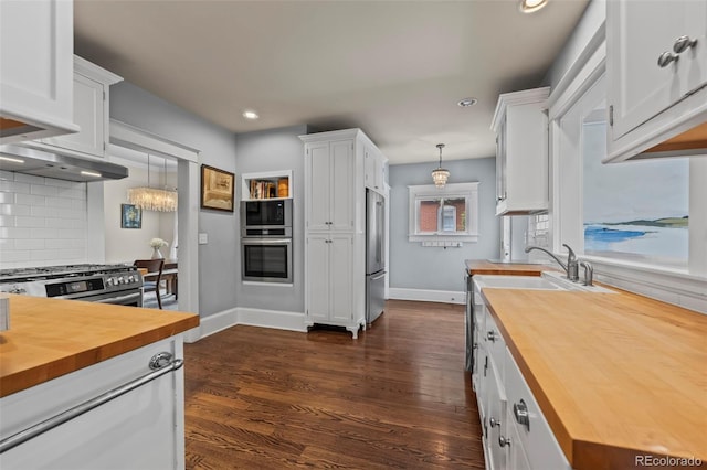 5675 S Crocker St, Littleton, CO 80120 - kitchen with wood counters, stainless steel appliances, backsplash, white cabinets, and recessed lighting