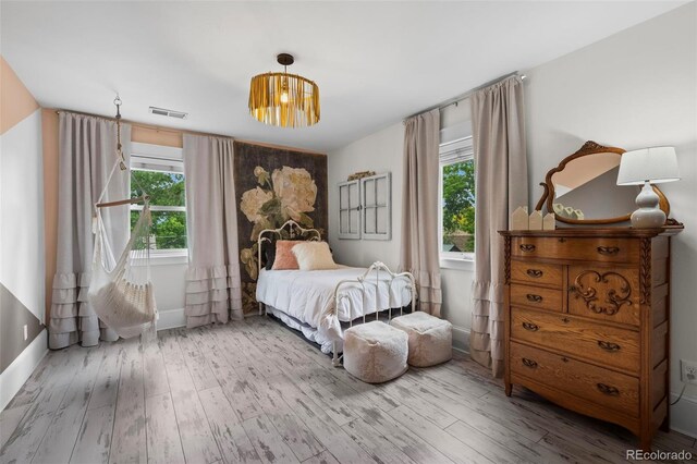 5675 S Crocker St, Littleton, CO 80120 - bedroom featuring multiple windows, wood finished floors, and baseboards