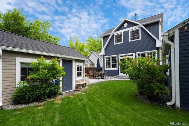 5675 S Crocker St, Littleton, CO 80120 - back of property with a lawn, a patio area, an outbuilding, and entry steps