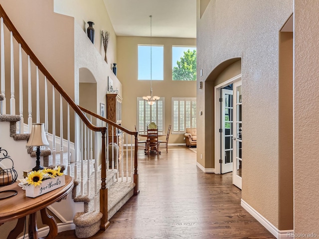 11074 Grayledge Cir, Highlands Ranch, CO 80130 - entrance foyer featuring a chandelier, wood finished floors, stairs, a high ceiling, and a textured wall