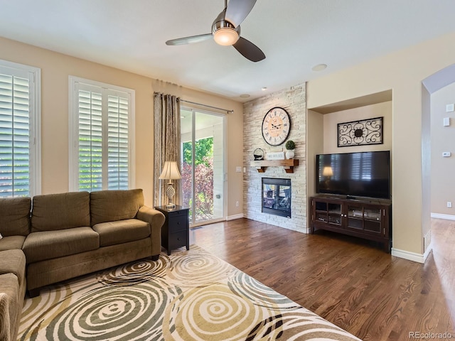 11074 Grayledge Cir, Highlands Ranch, CO 80130 - living room featuring a ceiling fan, a stone fireplace, and wood finished floors