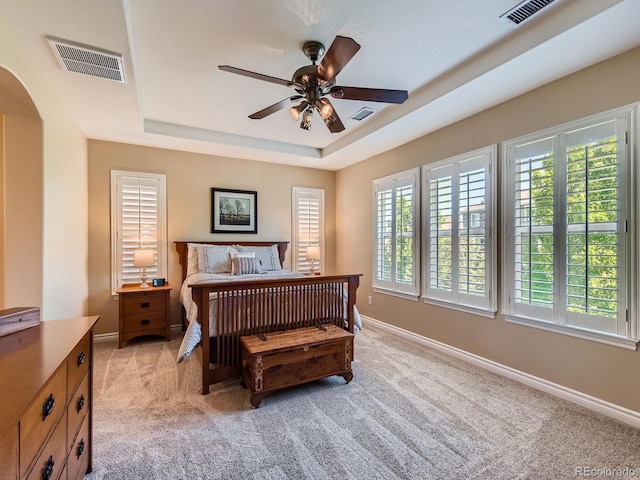 11074 Grayledge Cir, Highlands Ranch, CO 80130 - bedroom featuring a raised ceiling, light carpet, arched walkways, and ceiling fan