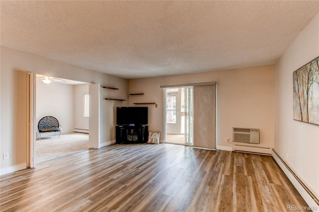 unfurnished living room with a baseboard radiator, wood finished floors, and a wall mounted air conditioner