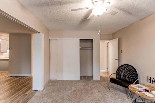 bedroom with a closet, ceiling fan, and a textured ceiling