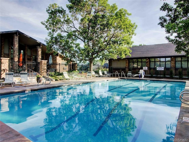 pool featuring fence and a patio