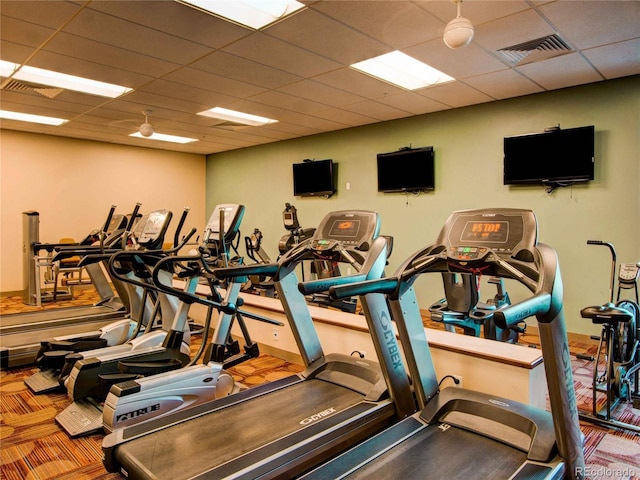 exercise room featuring a paneled ceiling and visible vents