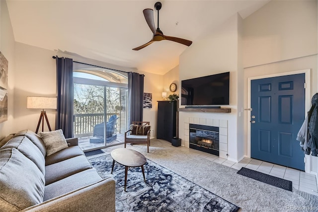 tiled living room with ceiling fan, a fireplace, and high vaulted ceiling