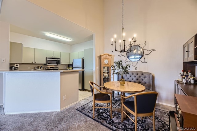 carpeted dining room with an inviting chandelier