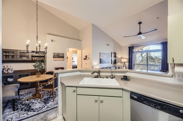 kitchen featuring lofted ceiling, sink, ceiling fan with notable chandelier, and dishwasher