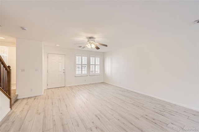 spare room with ceiling fan and light wood-type flooring