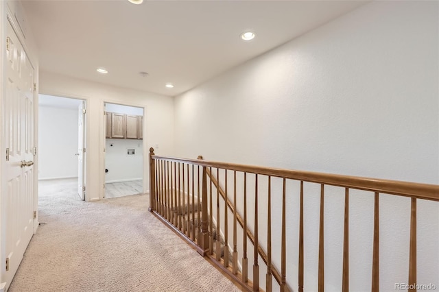 hallway featuring light carpet