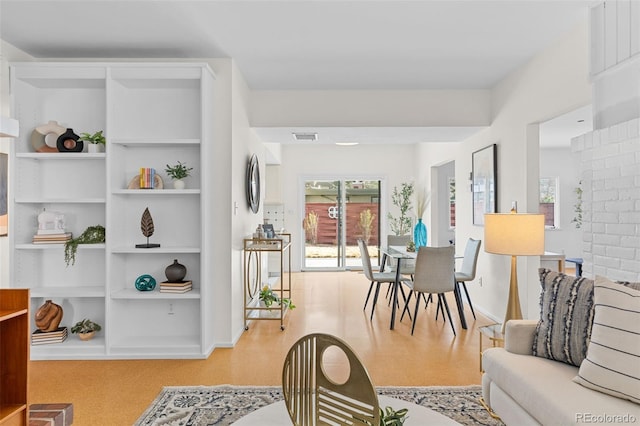 1420 E Bates Ave, Englewood, CO 80113 - living room with baseboards, visible vents, and built in shelves