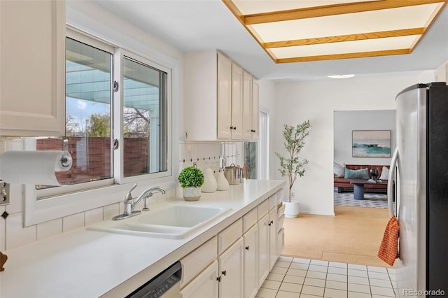 1420 E Bates Ave, Englewood, CO 80113 - kitchen featuring light colored carpet, a sink, light countertops, freestanding refrigerator, and light tile patterned flooring