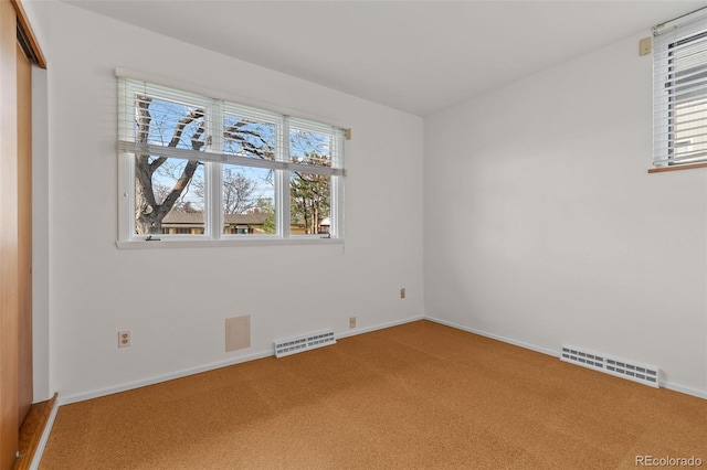 1420 E Bates Ave, Englewood, CO 80113 - unfurnished room featuring carpet floors, a wealth of natural light, and visible vents