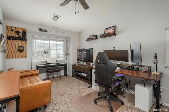 carpeted home office with visible vents, a ceiling fan, baseboards, and vaulted ceiling