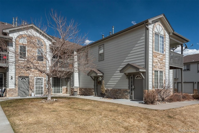 view of front of house featuring a front yard and stone siding