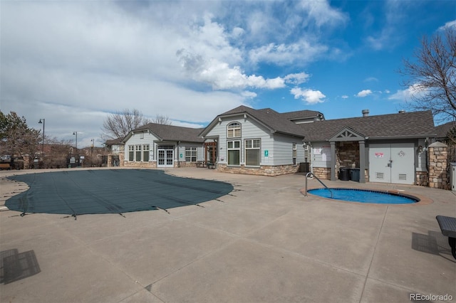 pool with a patio and french doors