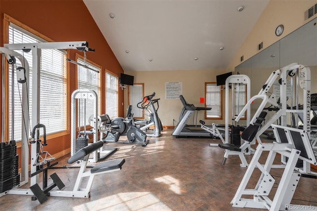 workout area with baseboards, visible vents, and high vaulted ceiling