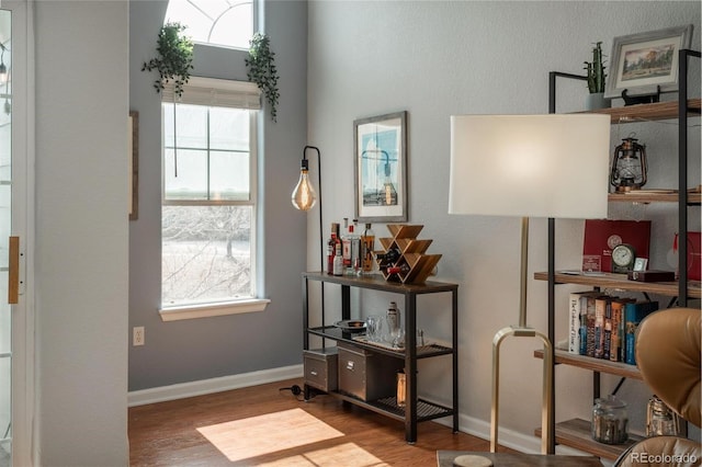 interior space featuring wood finished floors and baseboards