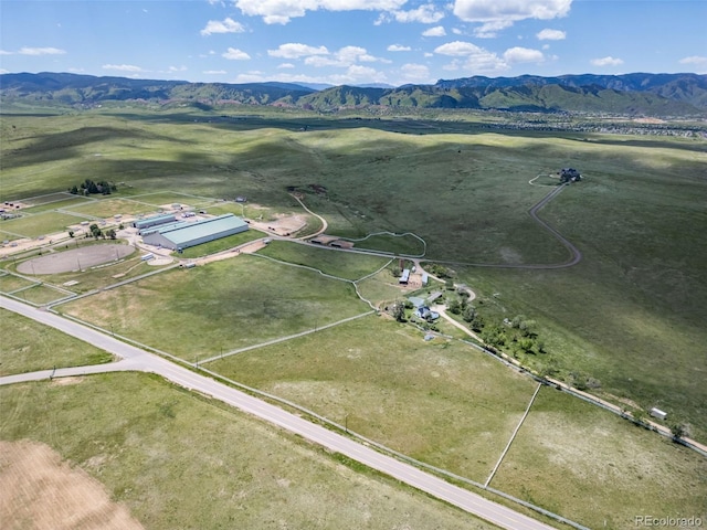 birds eye view of property with a mountain view and a rural view