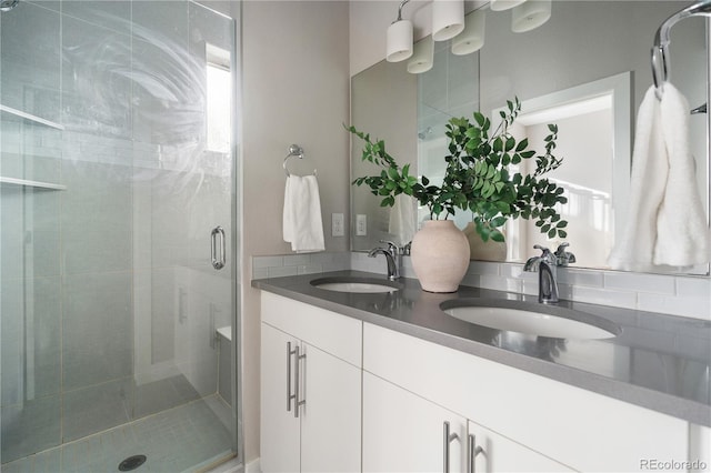 bathroom featuring vanity and an enclosed shower