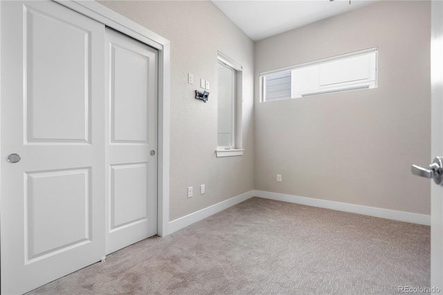 unfurnished bedroom with light colored carpet