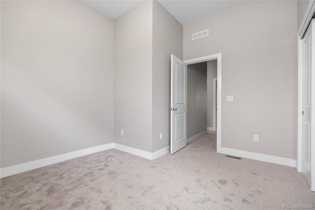 unfurnished bedroom featuring light colored carpet