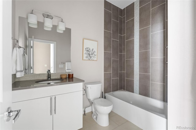 full bathroom with tiled shower / bath combo, vanity, tile patterned floors, and toilet