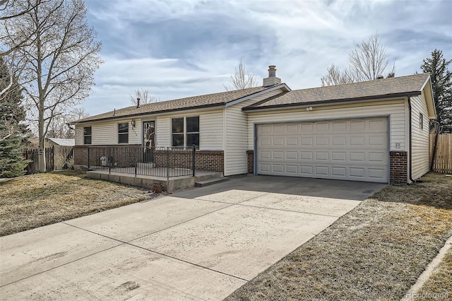 ranch-style house featuring brick siding, fence, concrete driveway, a chimney, and an attached garage