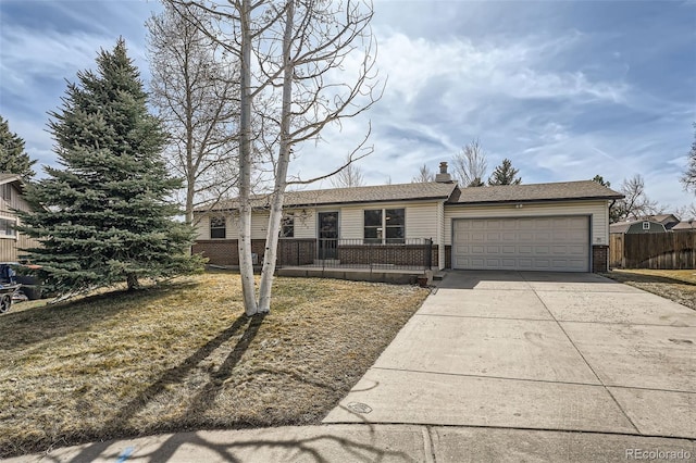 ranch-style home featuring concrete driveway, a garage, fence, and brick siding