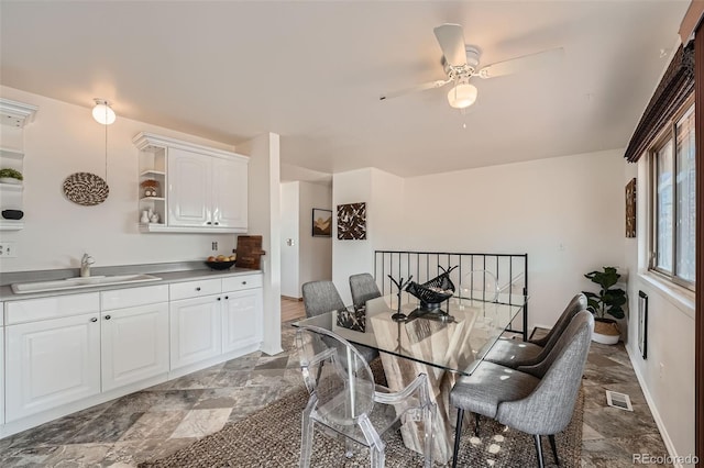 dining area with visible vents, baseboards, and ceiling fan