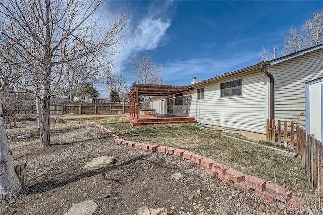 view of yard featuring fence and a wooden deck