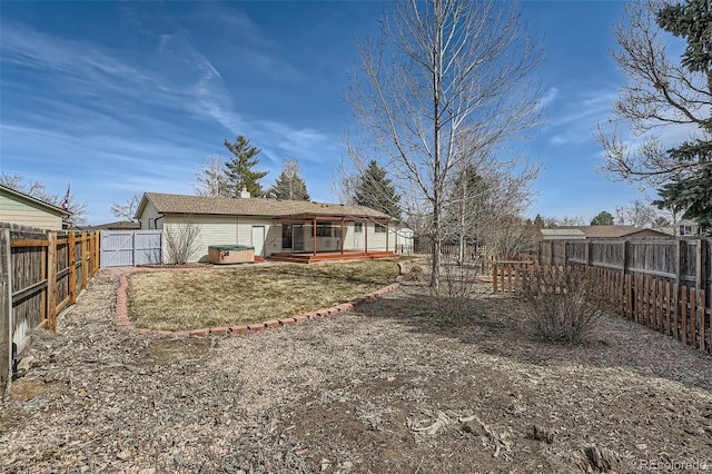 rear view of house with a fenced backyard