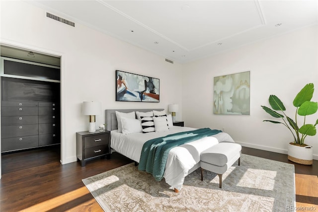 bedroom featuring dark wood finished floors, visible vents, and baseboards