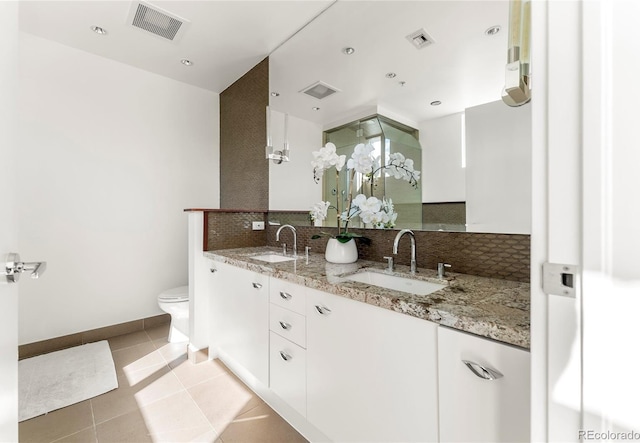 full bath featuring tasteful backsplash, a sink, visible vents, and tile patterned floors