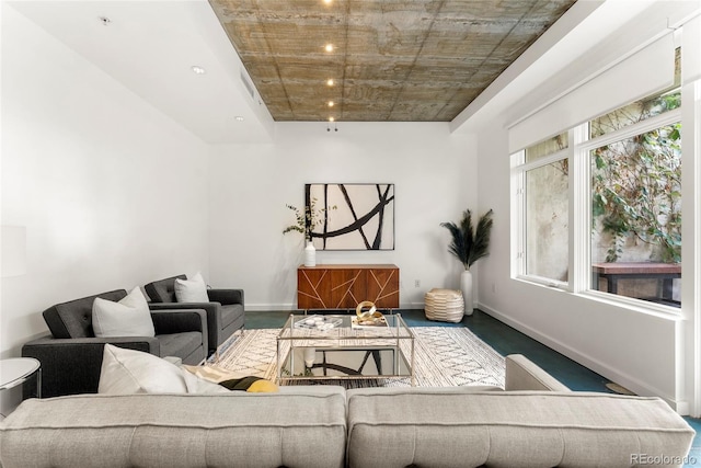 living area featuring a healthy amount of sunlight and baseboards