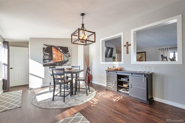 dining area with baseboards, dark wood finished floors, and a chandelier