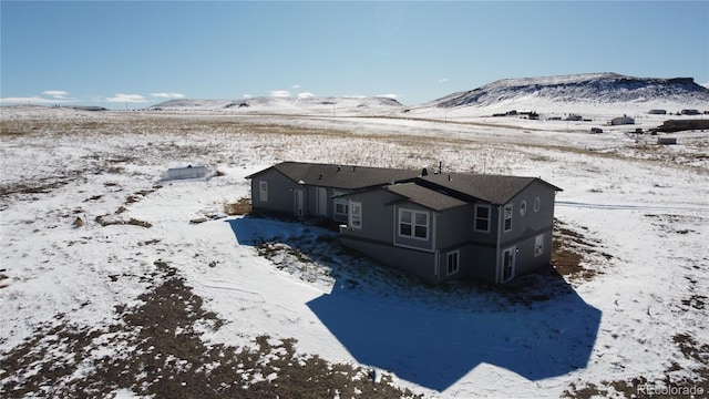 snowy aerial view featuring a mountain view