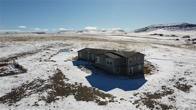 snowy aerial view with a mountain view