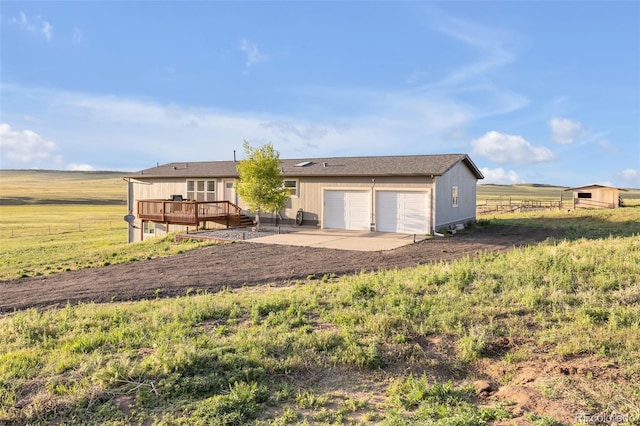 11100 Haskell Creek Rd, Larkspur, CO 80118 - rear view of house with a wooden deck, an attached garage, and a view of countryside