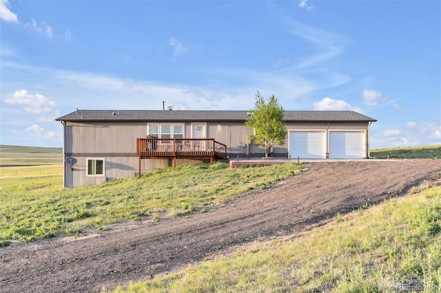 11100 Haskell Creek Rd, Larkspur, CO 80118 - view of front of house featuring a deck, driveway, and an attached garage
