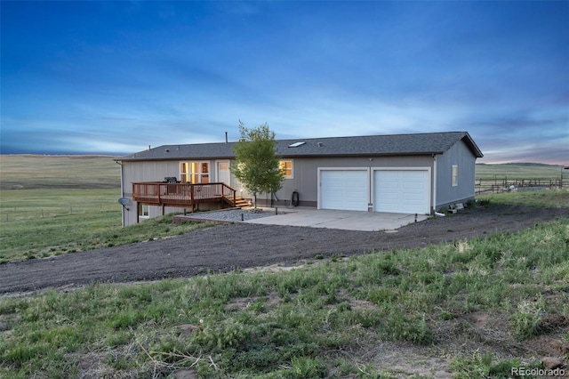 11100 Haskell Creek Rd, Larkspur, CO 80118 - view of front of house with a deck, an attached garage, and a view of countryside