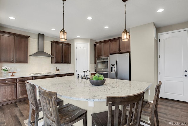 30 S Ider Way, Aurora, CO 80018 - kitchen with wall chimney range hood, appliances with stainless steel finishes, dark wood-type flooring, backsplash, and recessed lighting
