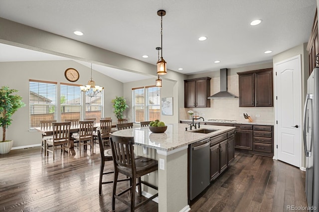 30 S Ider Way, Aurora, CO 80018 - kitchen with wall chimney range hood, stainless steel appliances, a sink, dark brown cabinets, and dark wood finished floors