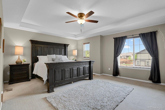 30 S Ider Way, Aurora, CO 80018 - bedroom featuring a tray ceiling, carpet flooring, baseboards, and ceiling fan