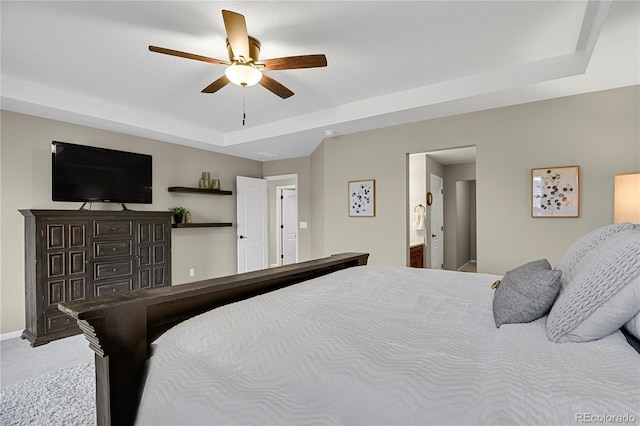 30 S Ider Way, Aurora, CO 80018 - carpeted bedroom with a tray ceiling, ceiling fan, and connected bathroom