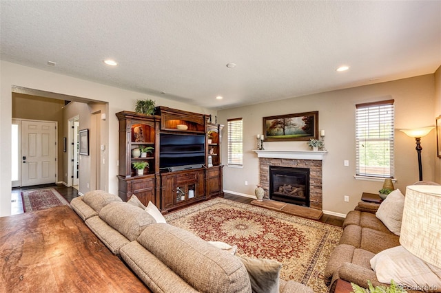 30 S Ider Way, Aurora, CO 80018 - living room featuring recessed lighting, a stone fireplace, and wood finished floors