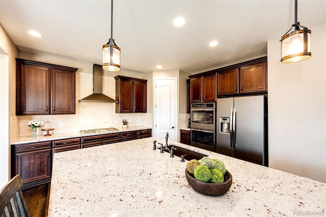30 S Ider Way, Aurora, CO 80018 - kitchen featuring stainless steel appliances, wall chimney exhaust hood, recessed lighting, decorative light fixtures, and light stone countertops